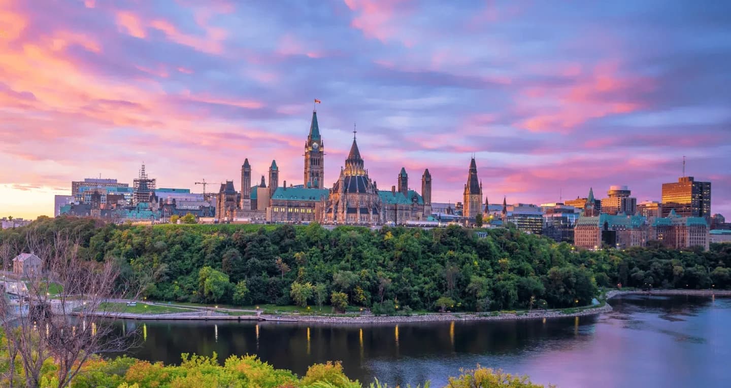Parliament Hill and the Ottawa River at sunset in Ottawa, Canada