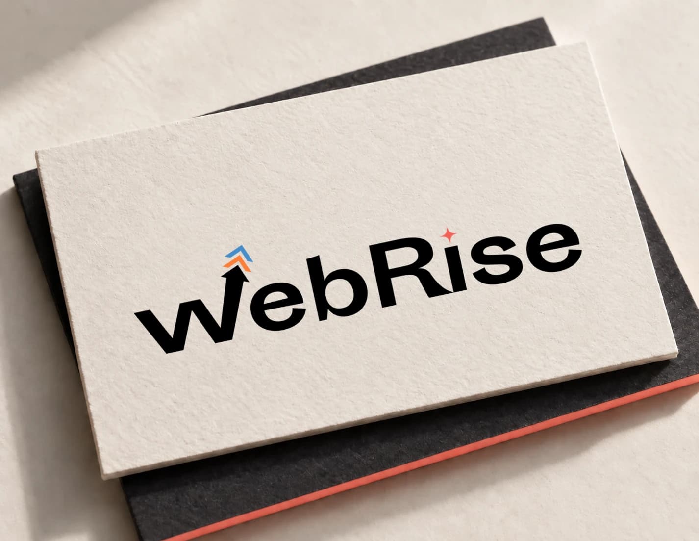 WebRise visual identity presented on textured ivory stationery