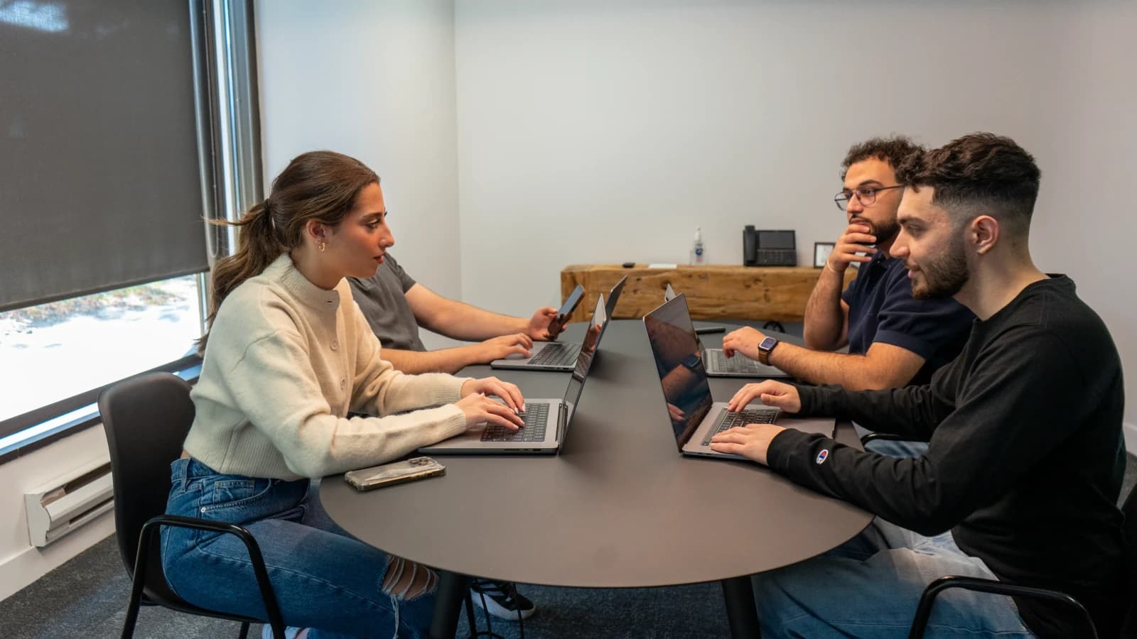 The WebRise team working together around the studio table
