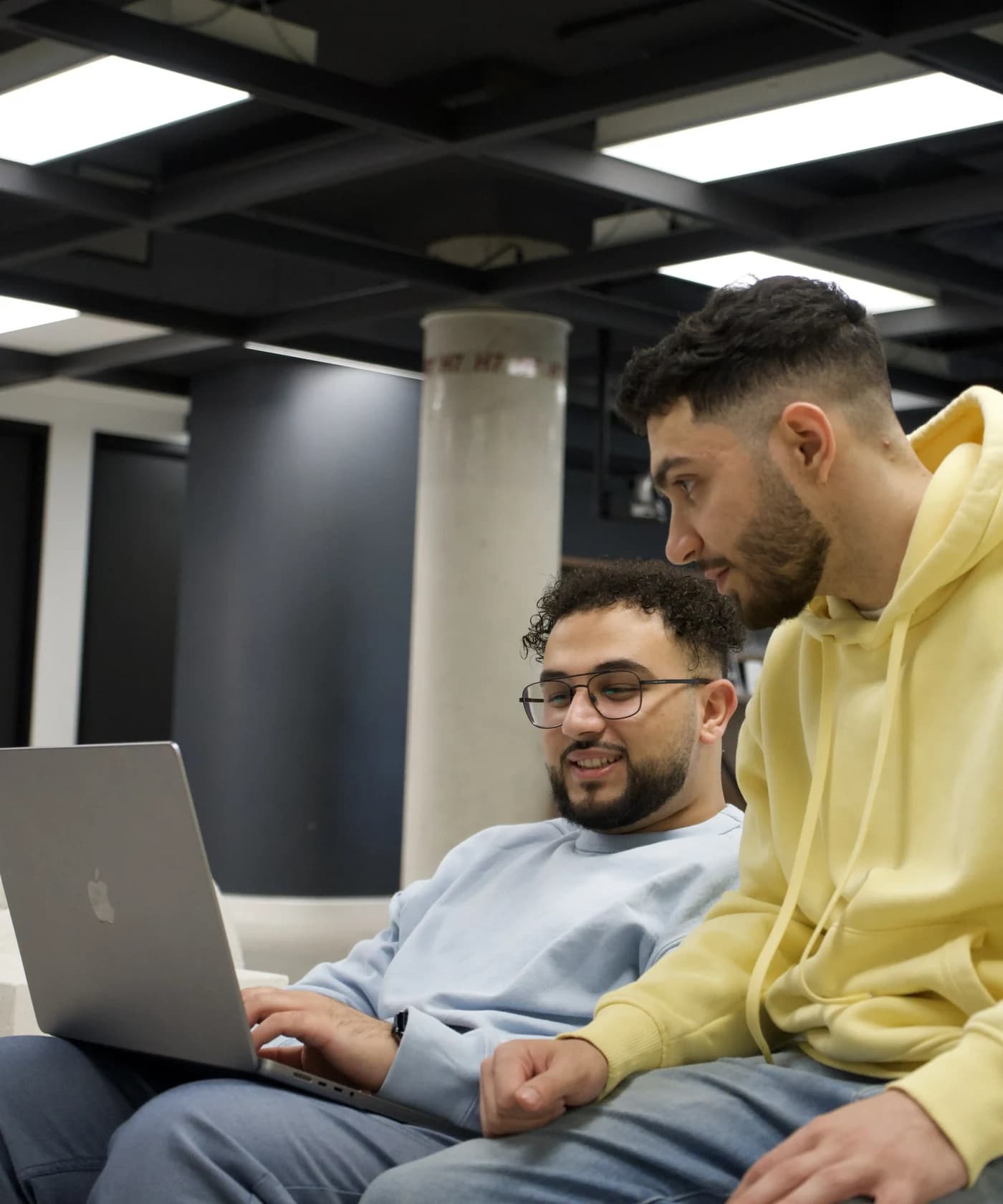 The team reviewing work together at a laptop