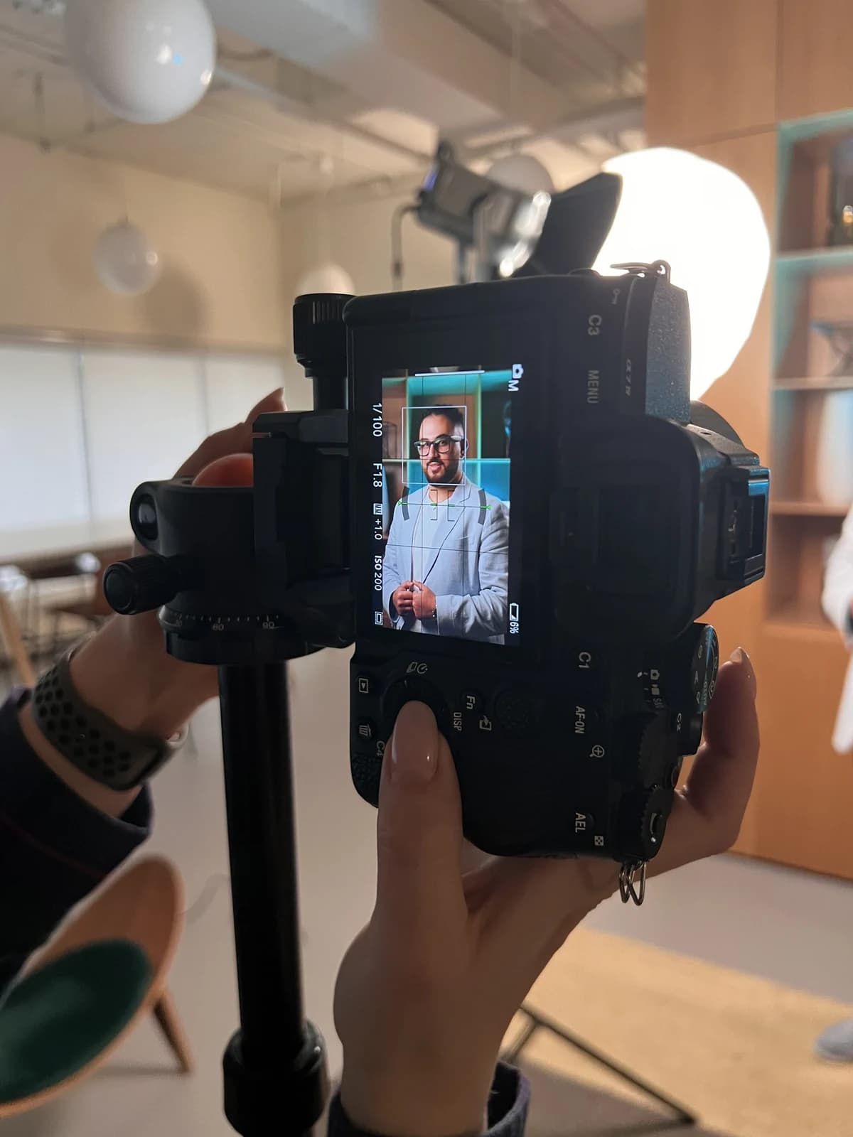A studio photo session seen from behind the camera
