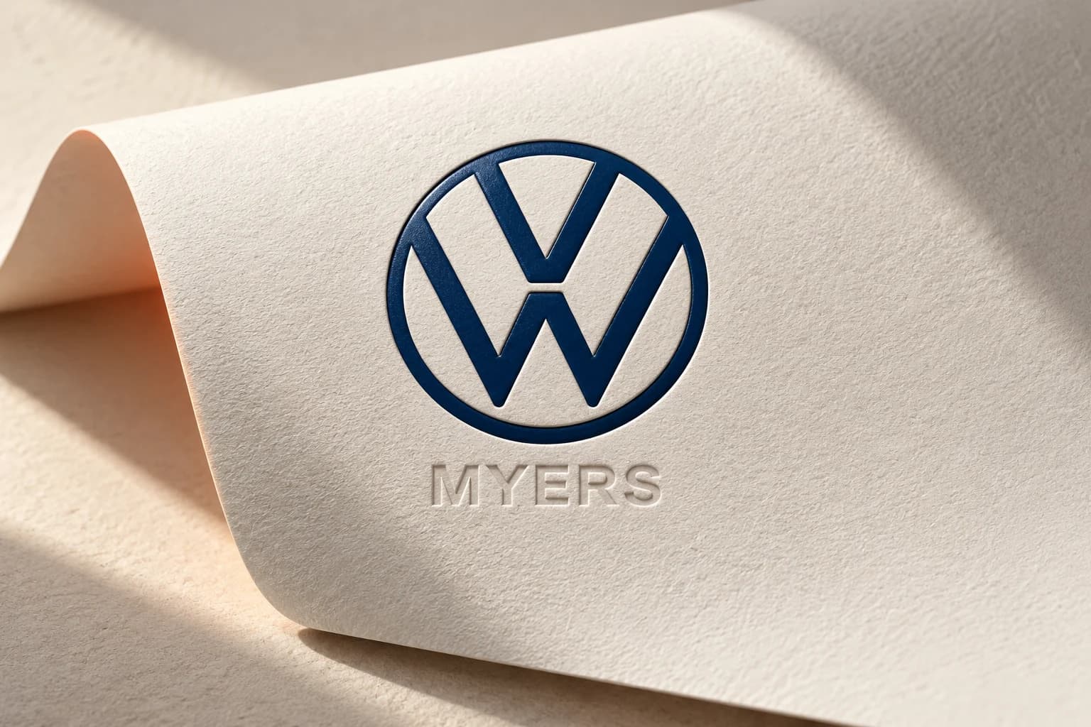 Myers Kanata Volkswagen portfolio artwork with a blue VW emblem on ivory paper